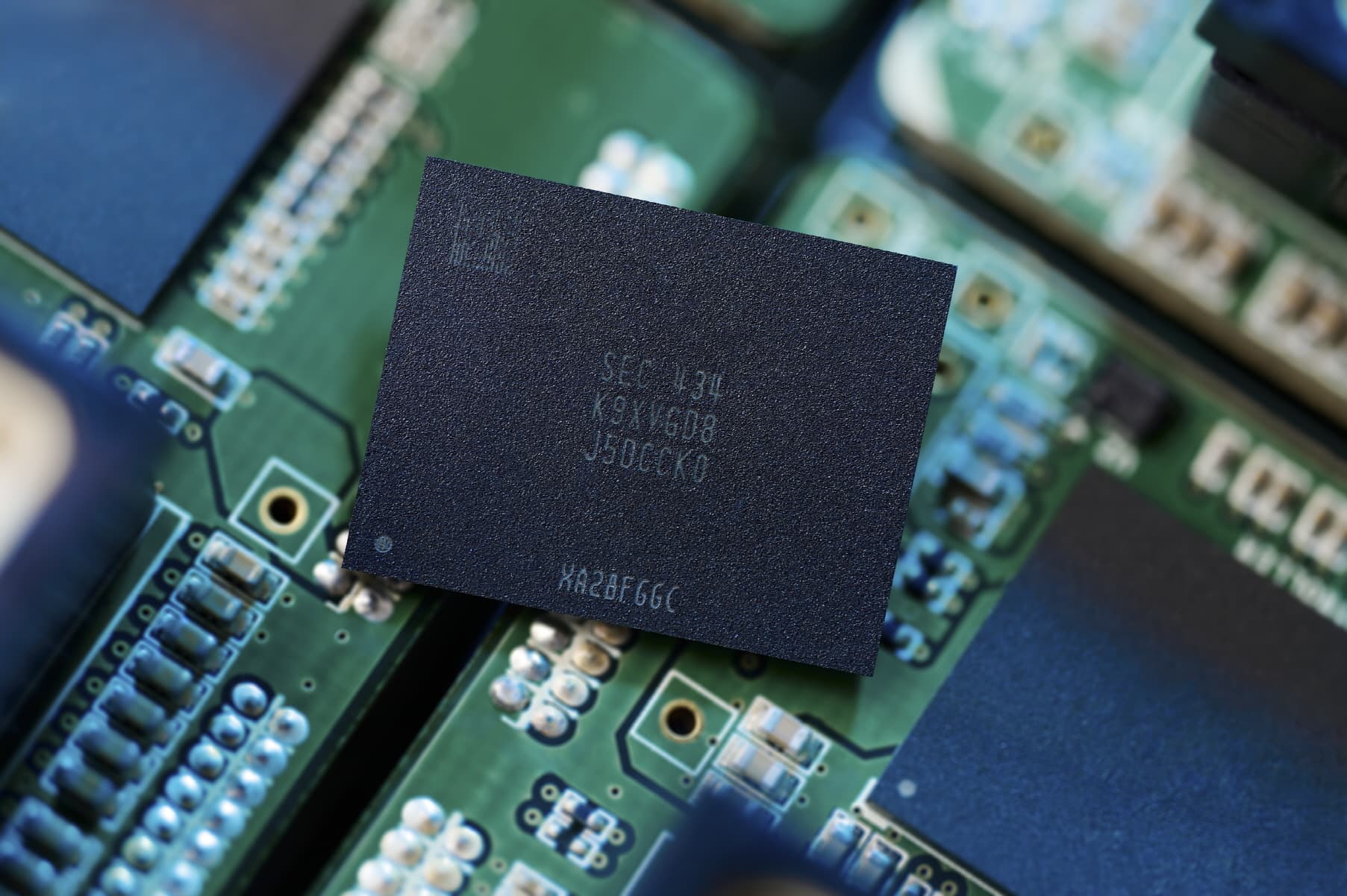 Close-up of a Samsung V-NAND flash memory chip resting on a green circuit board