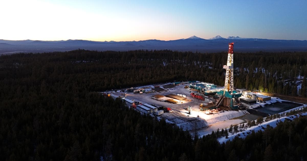 Geothermal drilling rig lit at dusk on a forested site, from the BLM geothermal lease sale announcement